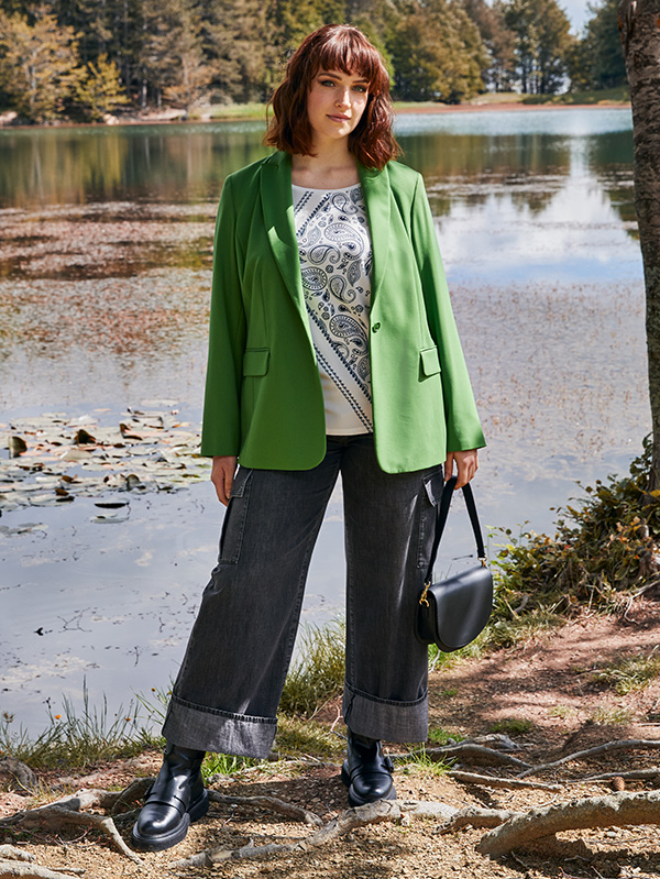 Modella indossa blazer verde e jeans